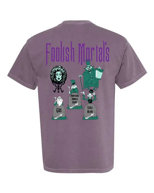 Purple t-shirt featuring cartoon haunted house characters and 'Foolish Mortals' text on back